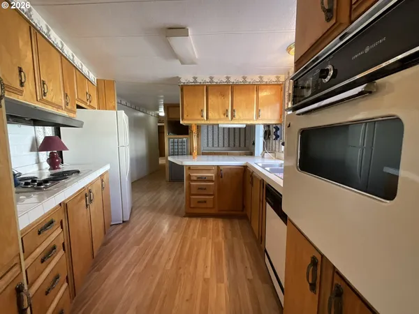 a kitchen with stainless steel appliances a microwave a stove and a refrigerator
