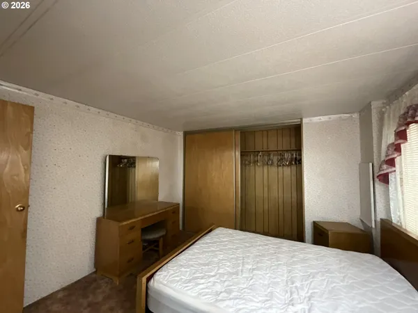 a bedroom with a bed and a television