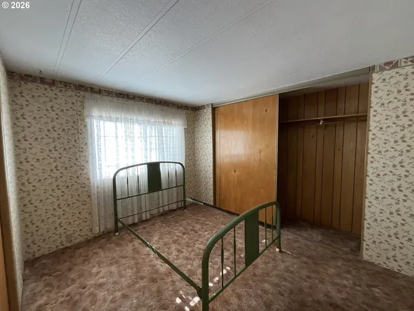 a view of hallway with a large window and chandelier