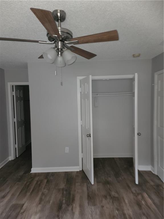 6130 Geiger Street Northwest Covington, GA 30014 - Photo 12 of 23 an empty room with wooden floor closet fan and windows