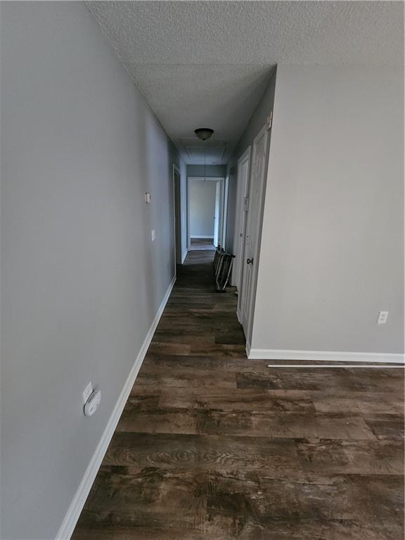 6130 Geiger Street Northwest Covington, GA 30014 - Photo 17 of 23 a view of a hallway with wooden floor and a white door
