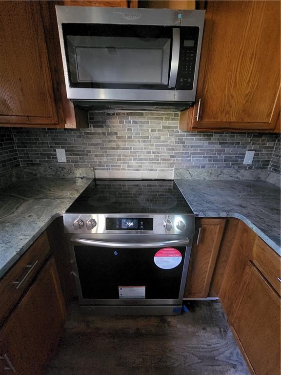 6130 Geiger Street Northwest Covington, GA 30014 - Photo 18 of 23 a kitchen with a stove and a microwave