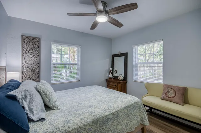 a bedroom with a bed couches and window