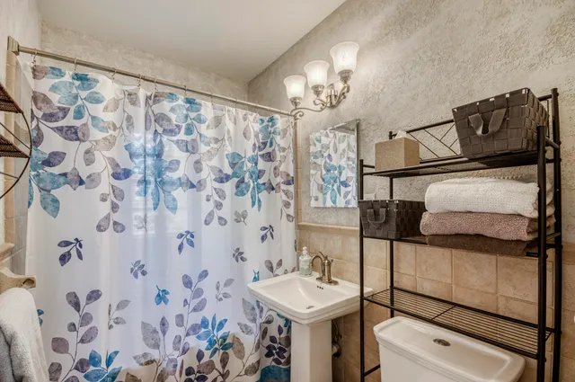 a bathroom with a sink toilet and shower