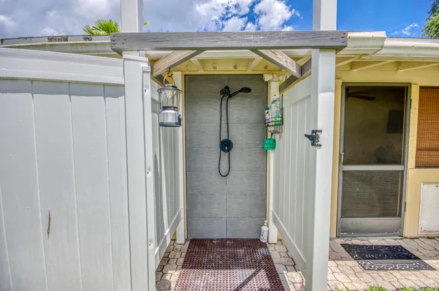an aerial view of residential house with outdoor space and trees all around