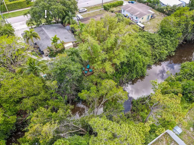 an aerial view of a house with a yard and garden