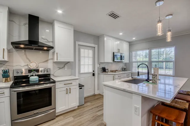 a kitchen with a sink stove and cabinets