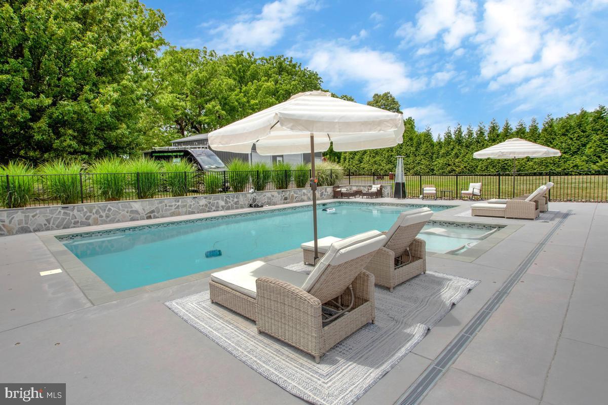 5 Jessie Road Harwood, MD 20776 - Photo 75 of 87 a view of a patio with a table and chairs under an umbrella