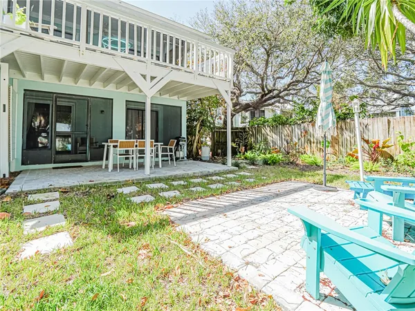 a view of a house with garden and sitting area