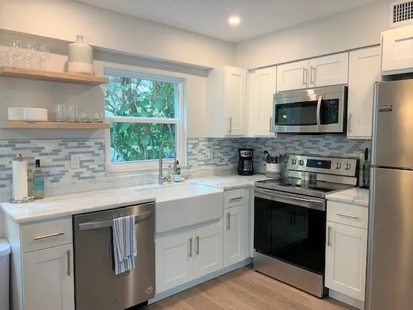 a kitchen with a sink stove and microwave