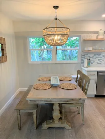 a view of a dining room with furniture window and outside view