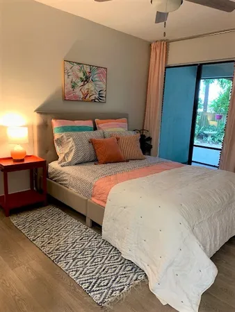 a bedroom with a bed and a painting on the wall