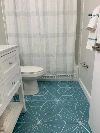 a bathroom with a toilet and a shower