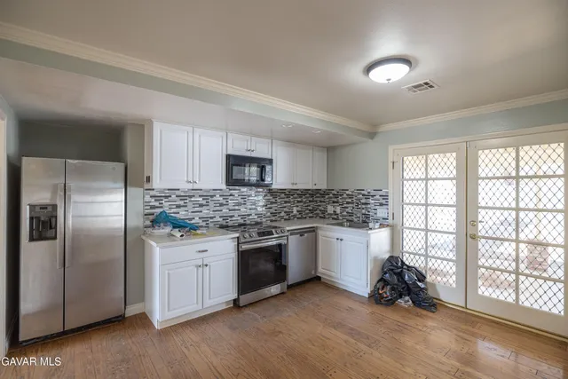 a kitchen with stainless steel appliances granite countertop a stove and a sink