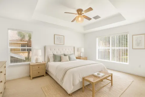 a bedroom with a bed next to a window