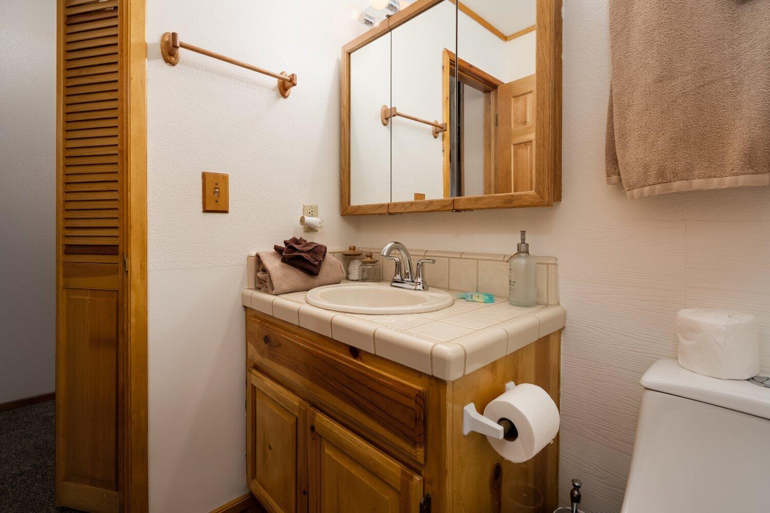 42363 Paramount Road Big Bear Lake, CA 92315 - Photo 19 of 38 a bathroom with a sink and a mirror