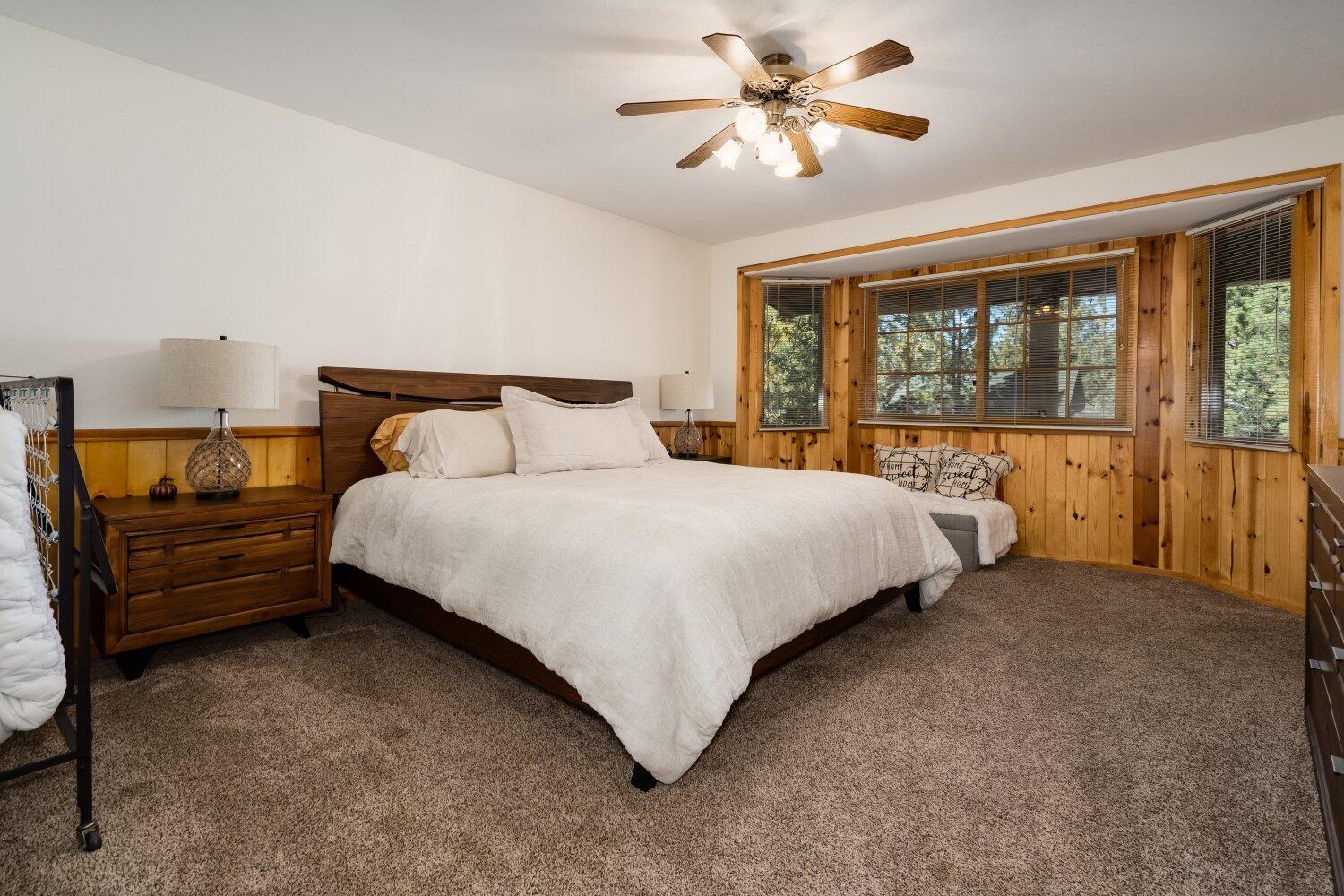 42363 Paramount Road Big Bear Lake, CA 92315 - Photo 21 of 38 a bedroom with a bed ceiling fan and a large window