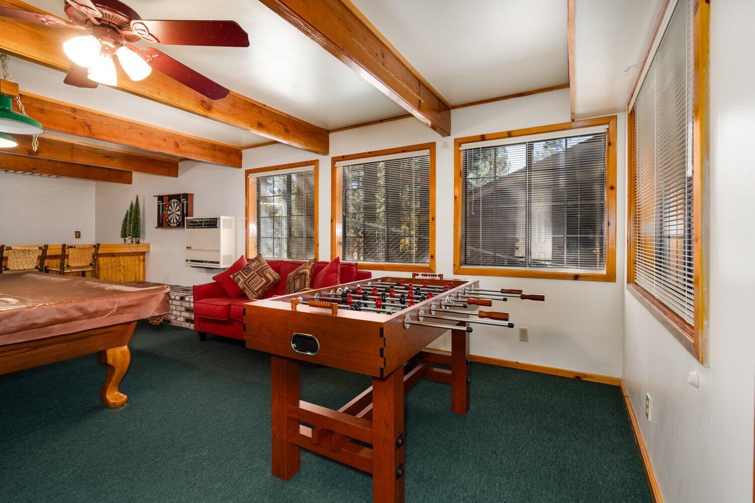 42363 Paramount Road Big Bear Lake, CA 92315 - Photo 33 of 38 a living room with furniture a flat screen tv and large windows