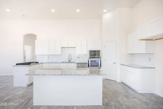 a kitchen with a sink a stove and cabinets