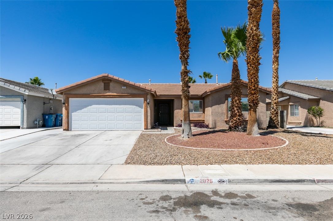2028 Rustler Ridge Avenue North Las Vegas, NV 89031 - Photo 2 of 40 A desert-friendly landscape accents this property with mature palm trees and low-maintenance rock beds.