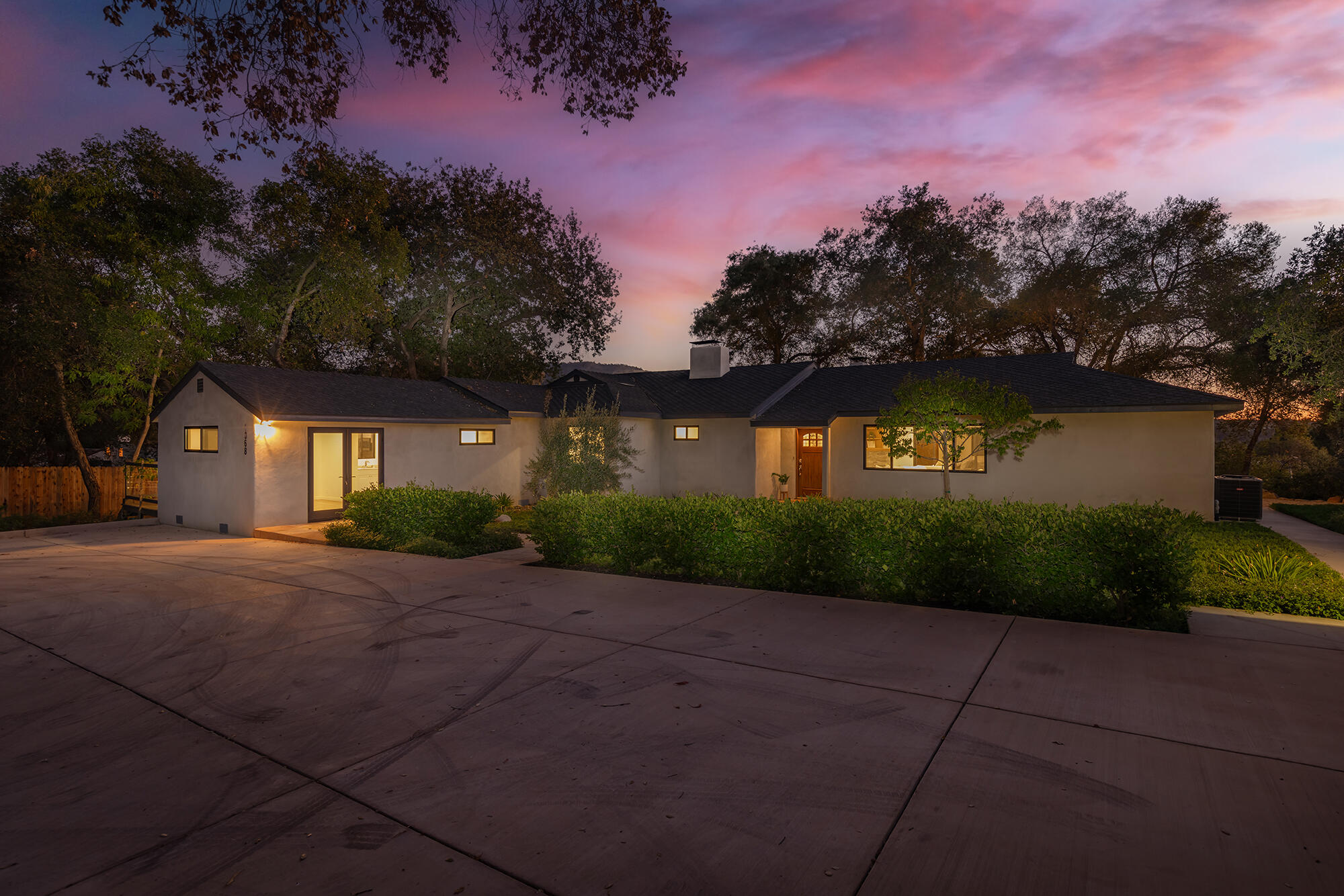 1068 Cuyama Road Ojai, CA 93023 - Photo 14 of 43 a front view of a house with a yard and a garage