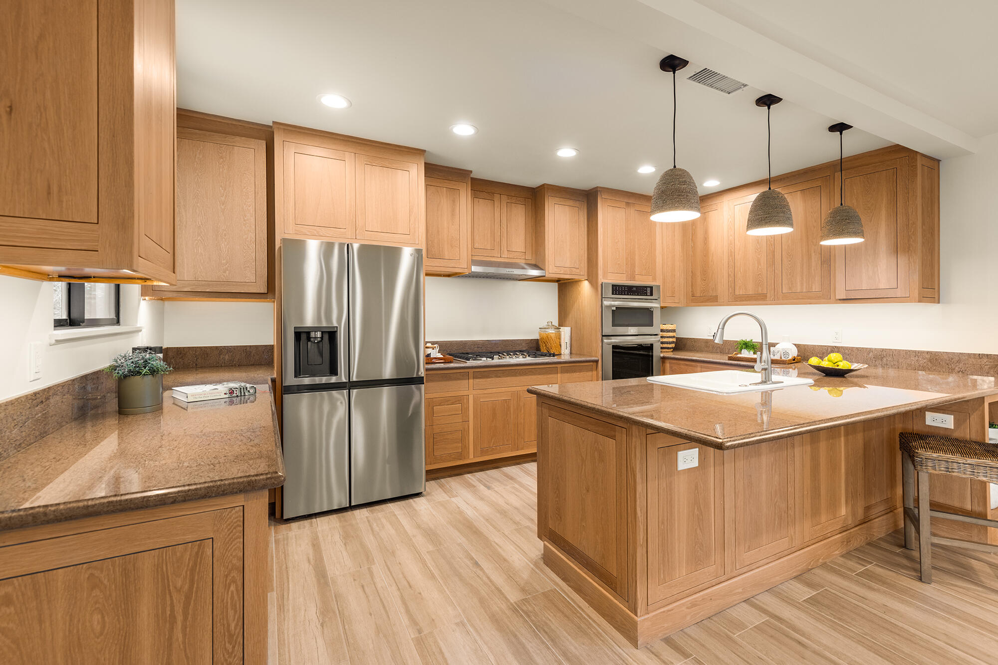 1068 Cuyama Road Ojai, CA 93023 - Photo 18 of 43 a kitchen with a sink a kitchen island a stove a refrigerator cabinets and a counter top space