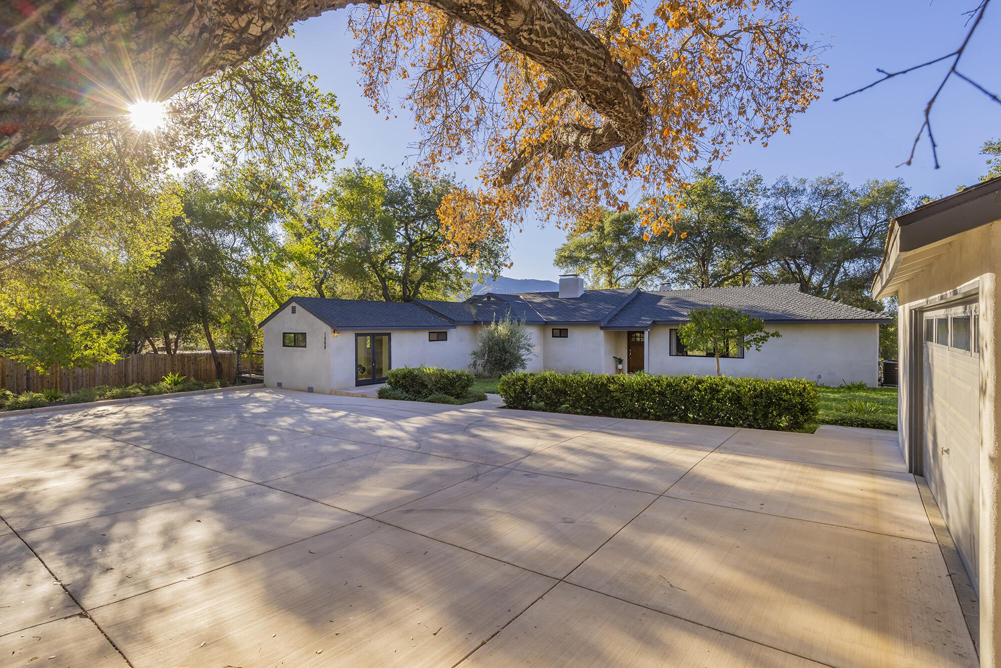 1068 Cuyama Road Ojai, CA 93023 - Photo 28 of 43 a front view of a house with a yard and garage