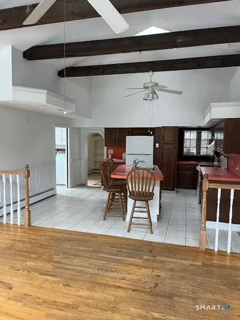 a dining room with furniture and wooden floor