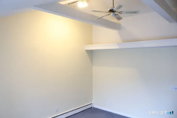 an empty room with a window and a ceiling fan
