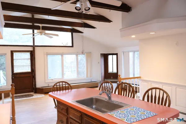 a dining room with furniture and window