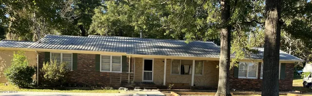 a view of a house with a tree