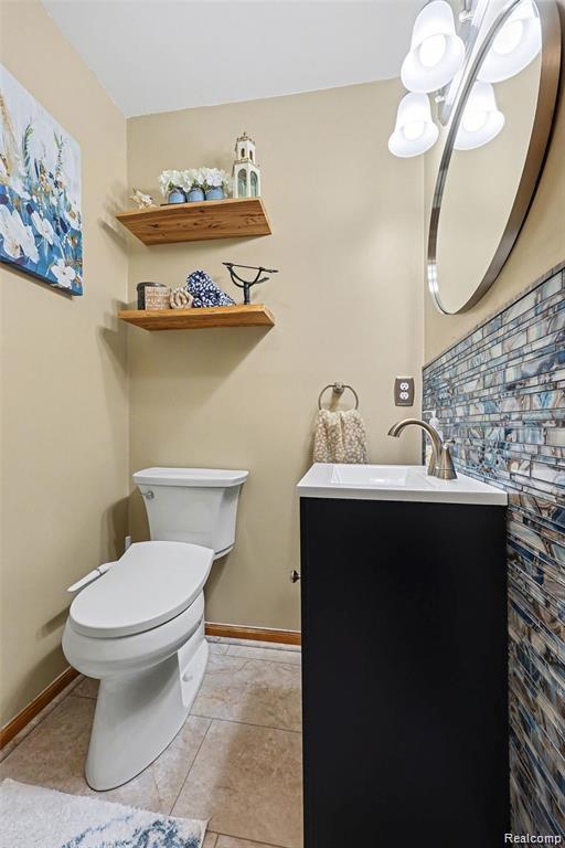 7277 Cardinal Road Algonac, MI 48001 - Photo 24 of 36 Half bath featuring vanity, hanging lights, and light tile patterned flooring
