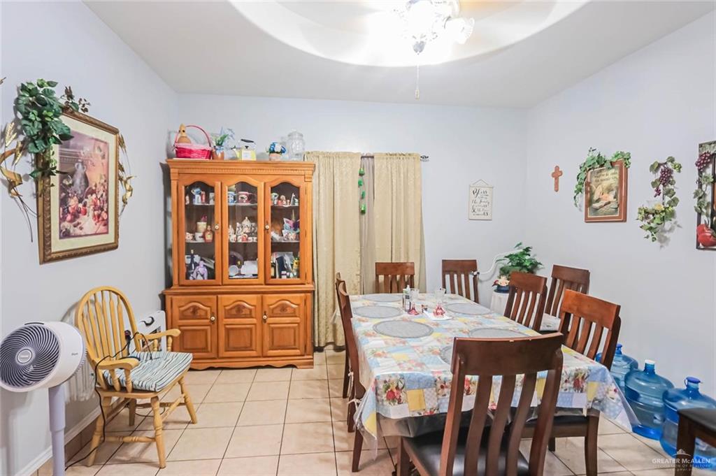 4701 Russell Circle Mission, TX 78574 - Photo 12 of 37 a view of a dining room with furniture wooden floor and a chandelier