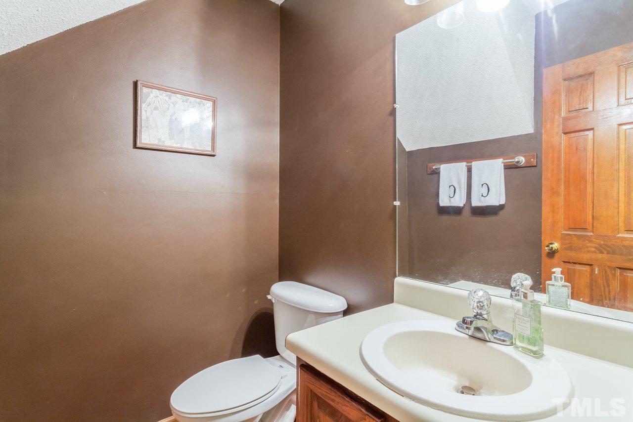 6679 English Ivy Lane Raleigh, NC 27615 - Photo 11 of 24 a bathroom with a sink mirror and toilet