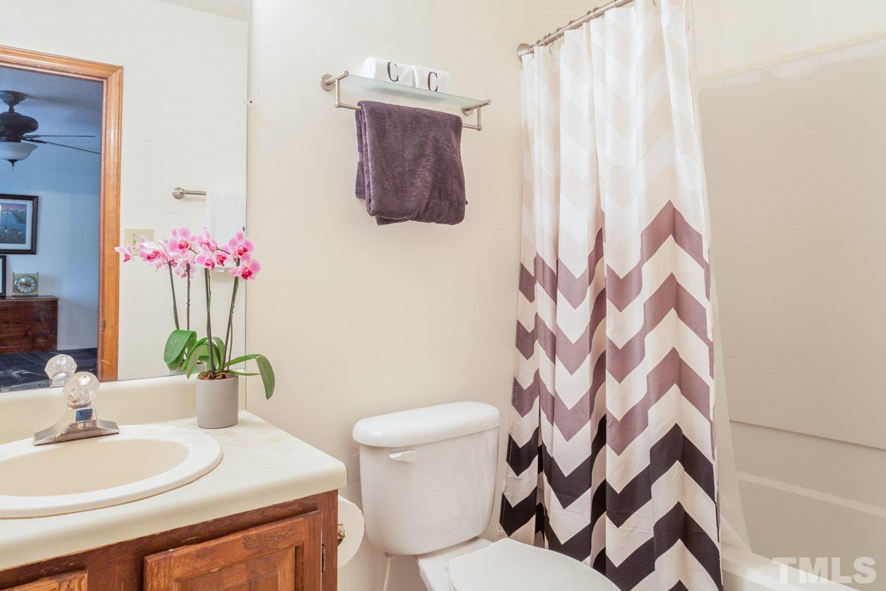 6679 English Ivy Lane Raleigh, NC 27615 - Photo 13 of 24 a bathroom with a sink toilet and a mirror