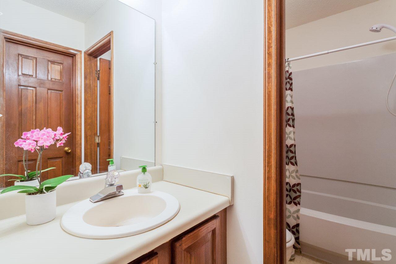 6679 English Ivy Lane Raleigh, NC 27615 - Photo 15 of 24 a bathroom with a sink and a mirror