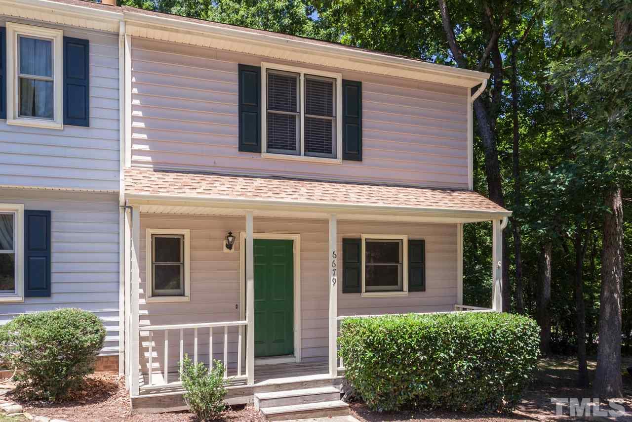 6679 English Ivy Lane Raleigh, NC 27615 - Photo 17 of 24 a view of a house with brick walls plants and large tree