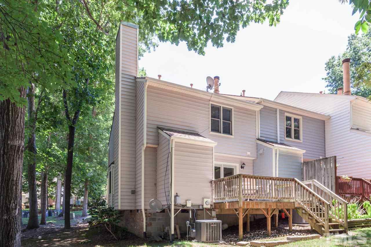 6679 English Ivy Lane Raleigh, NC 27615 - Photo 20 of 24 a front view of a building with trees