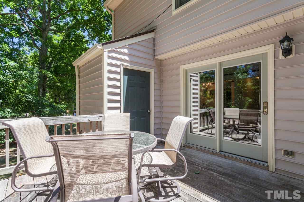 6679 English Ivy Lane Raleigh, NC 27615 - Photo 22 of 24 a view of a patio with table and chairs and potted plants