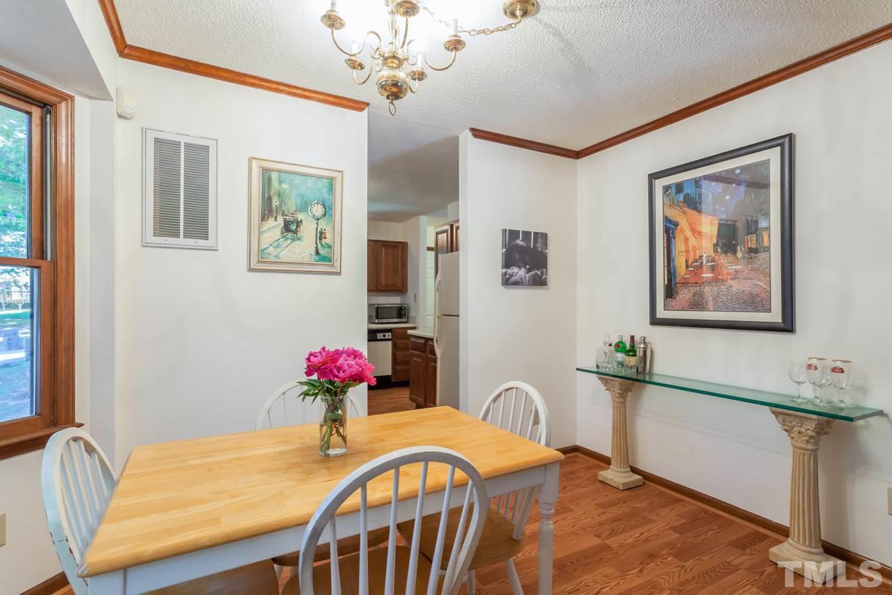 6679 English Ivy Lane Raleigh, NC 27615 - Photo 7 of 24 a view of a dining room with furniture and wooden floor