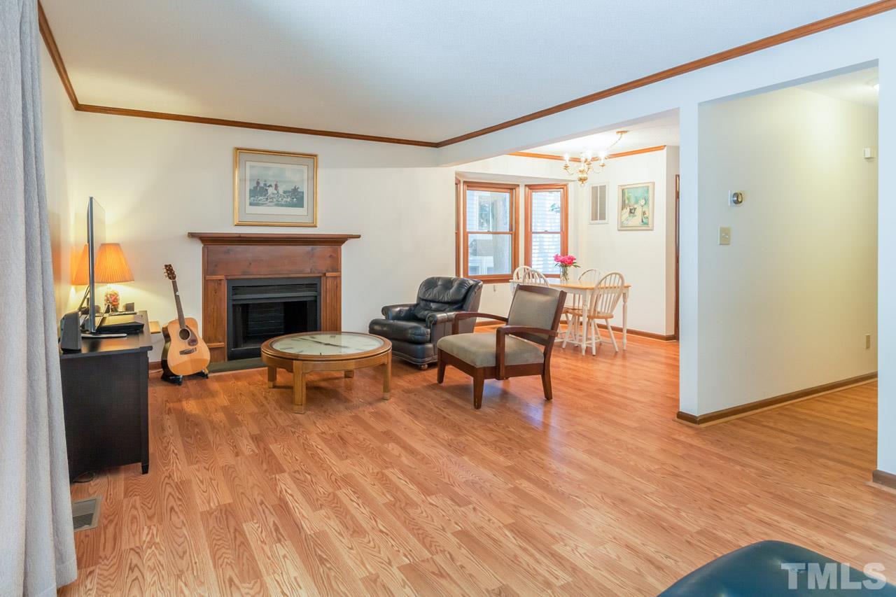 6679 English Ivy Lane Raleigh, NC 27615 - Photo 8 of 24 a living room with furniture and a fireplace