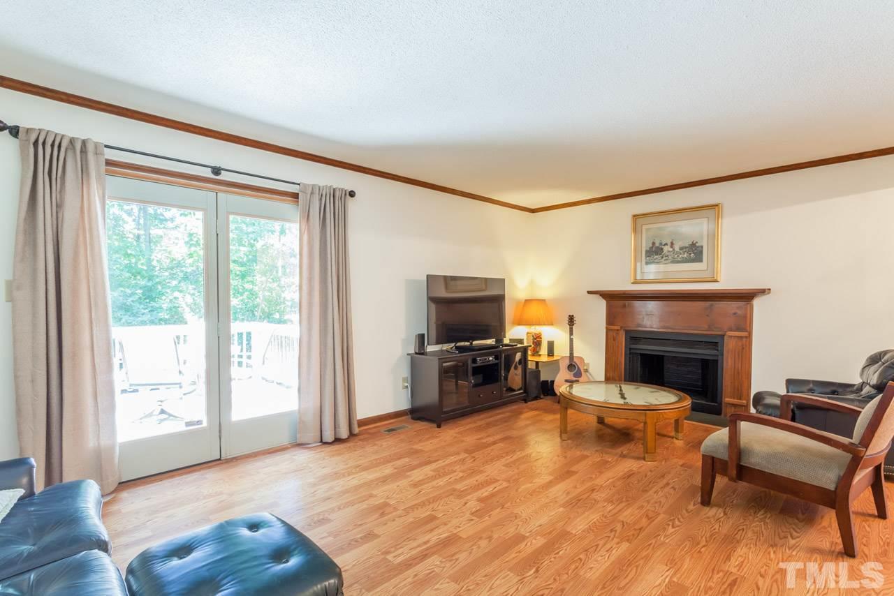 6679 English Ivy Lane Raleigh, NC 27615 - Photo 9 of 24 a living room with furniture and a fireplace