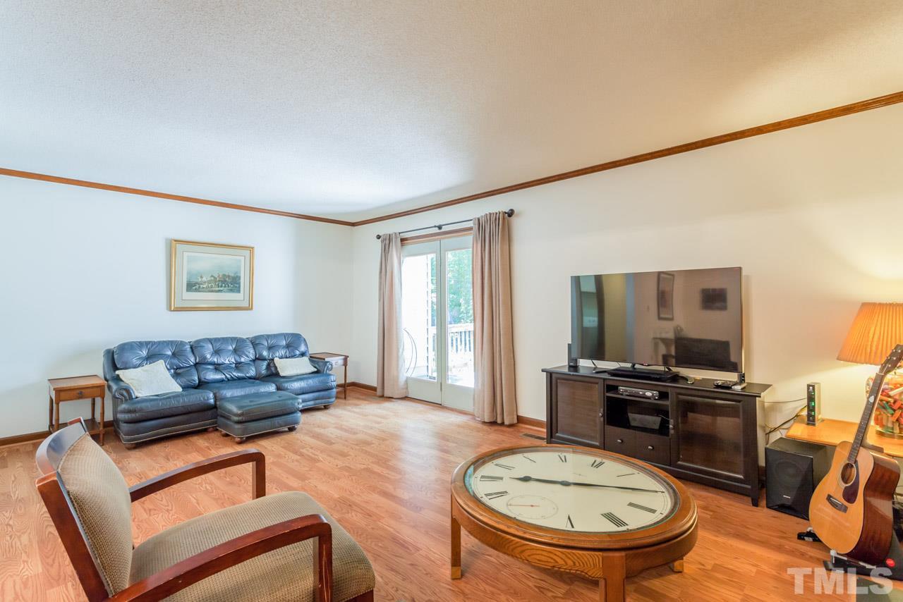 6679 English Ivy Lane Raleigh, NC 27615 - Photo 10 of 24 a living room with furniture and a wooden floor