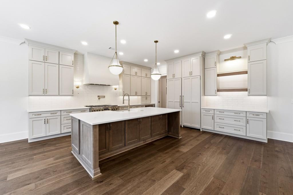 286 County Road Southwest Marietta, GA 30064 - Photo 13 of 40 a large kitchen with cabinets wooden floor and stainless steel appliances