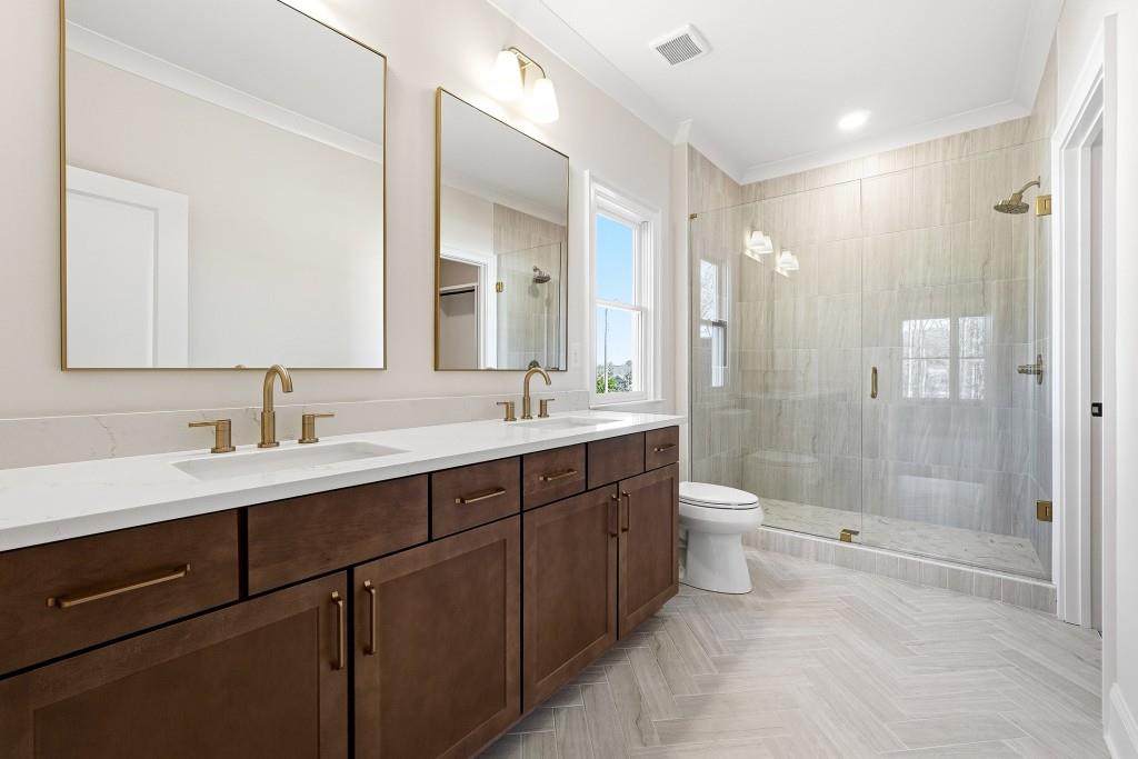 286 County Road Southwest Marietta, GA 30064 - Photo 30 of 40 a bathroom with a double vanity sink toilet and shower