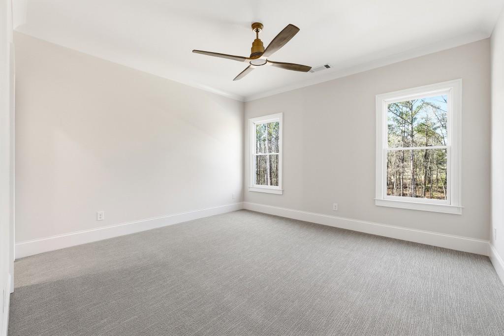 286 County Road Southwest Marietta, GA 30064 - Photo 34 of 40 an empty room with a ceiling fan and windows