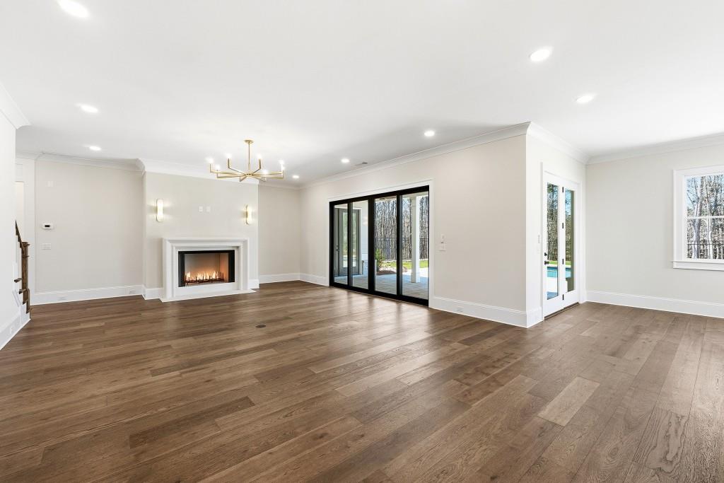 286 County Road Southwest Marietta, GA 30064 - Photo 10 of 40 an empty room with wooden floor fireplace and windows