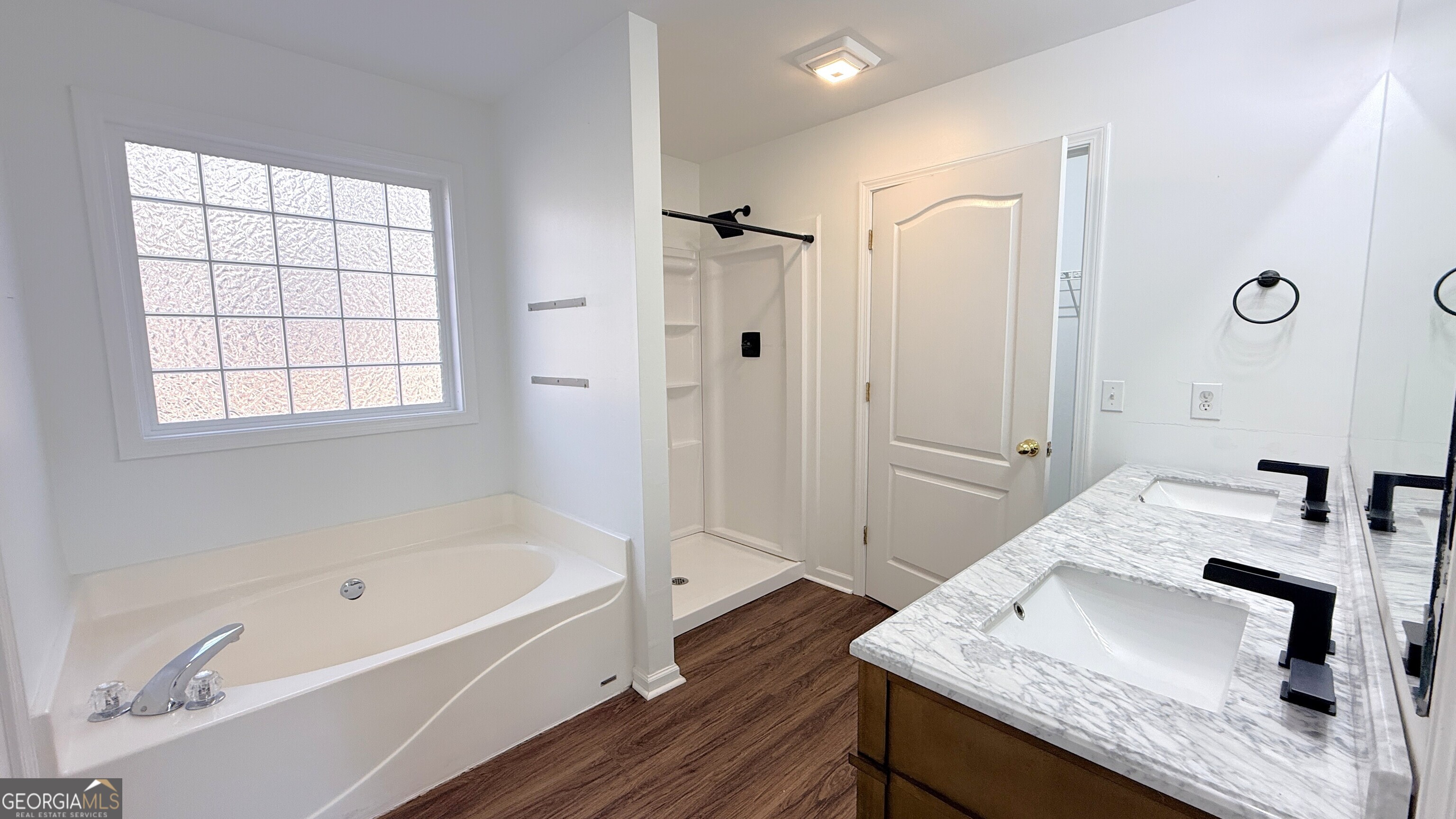 3395 Woodlake Lane Villa Rica, GA 30180 - Photo 13 of 25 a bathroom with a granite countertop tub sink and mirror