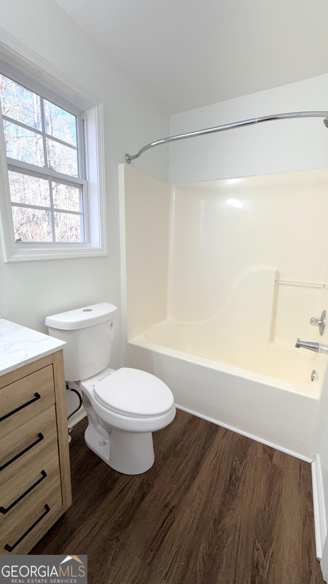 3395 Woodlake Lane Villa Rica, GA 30180 - Photo 14 of 25 a bathroom with a toilet a sink and a bathtub
