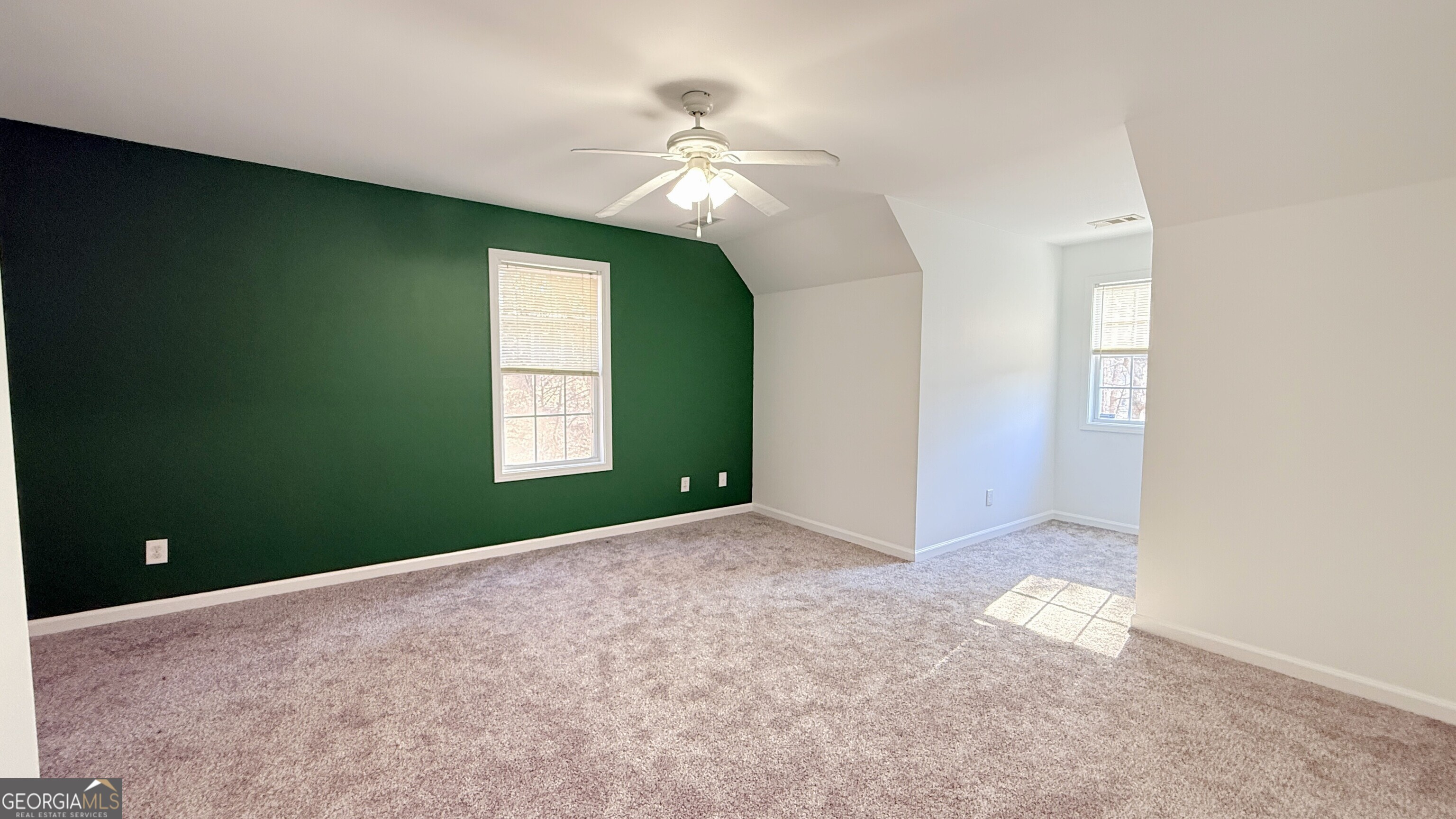 3395 Woodlake Lane Villa Rica, GA 30180 - Photo 18 of 25 an empty room with windows and fan